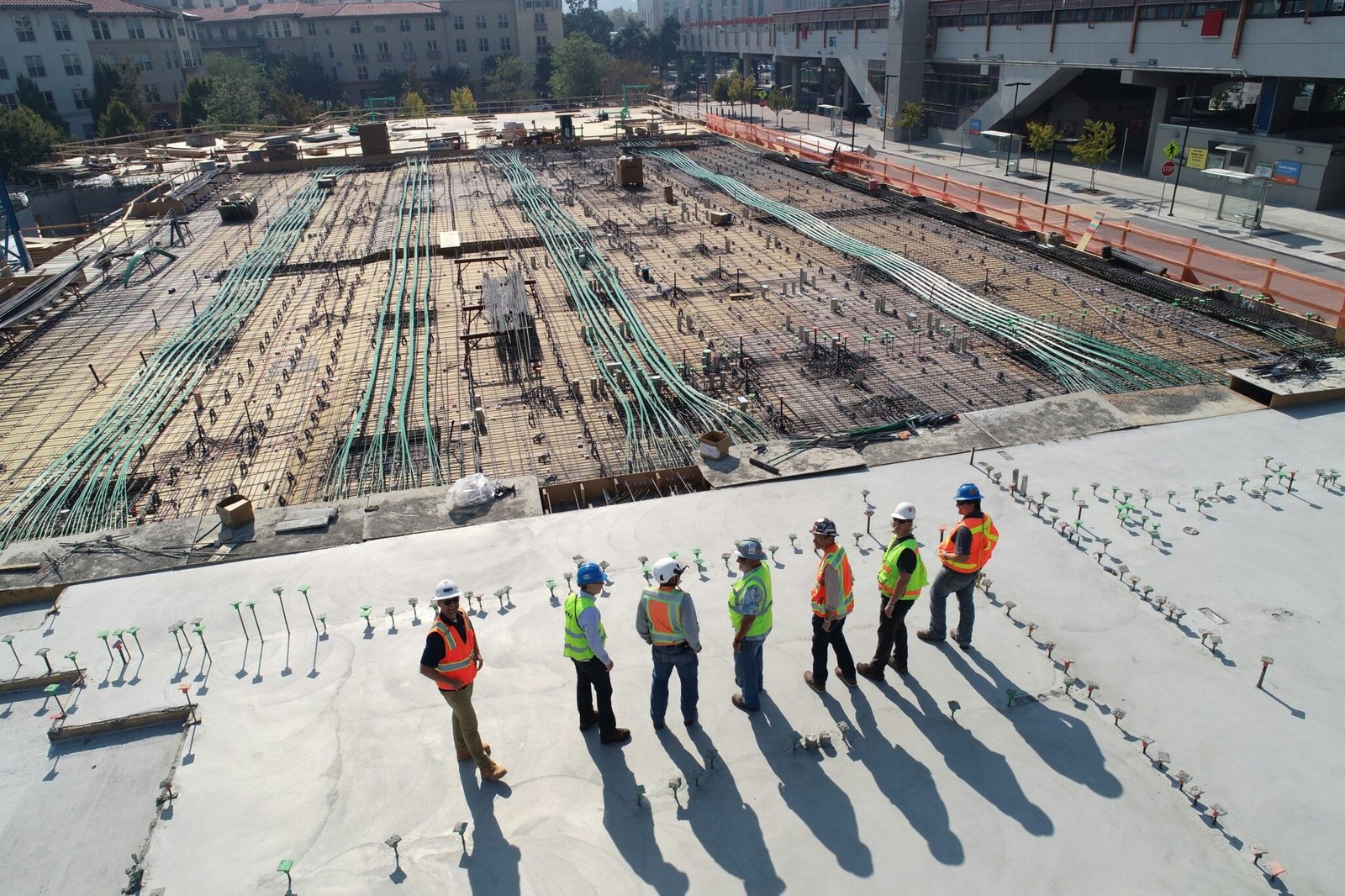 Construction workers overlooking a concrete slab